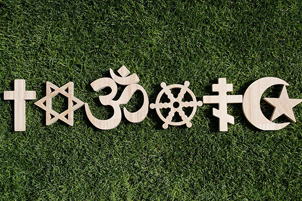 How should employers manage religious beliefs and discrimination in the workplace?